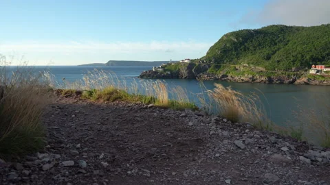 Two hikers on North Head trail pass in front of Fort Amherst Stock Footage 214488807