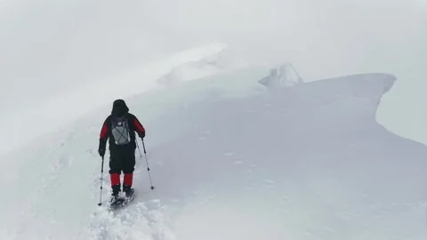 Two Hikers Pass A Dangerous Section Of The Trail - A Snowy Ledge. Stock Footage 219954815