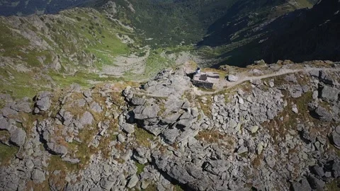 Two hikers reaching the highest peak in Rodnei mountains Видео 250331915