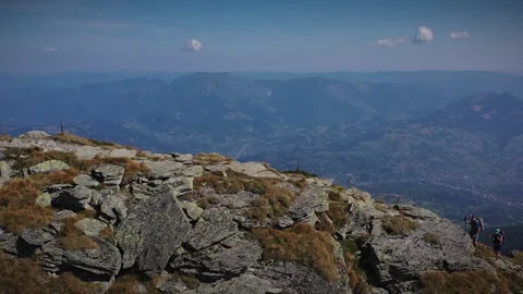 Two hikers reaching the highest peak in Rodnei mountains Видео 250332224