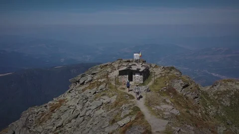 Two hikers reaching the highest peak in Rodnei mountains Видео 250332276