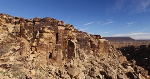 Two hikers rock climbing on the cliff on a sunny day Video stock 103827341