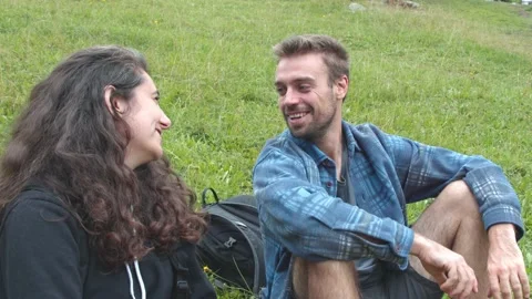Two hikers sitting on the grass. 스톡 동영상 208155181