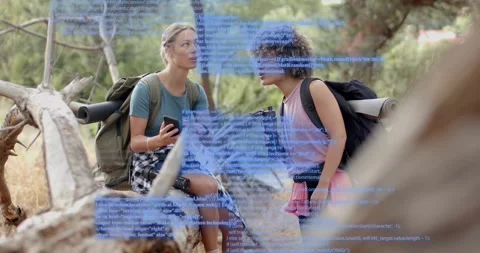 Two hikers on trail scrolling smartphone and examining blue technology code Stockbeeldmateriaal 317733255