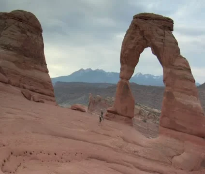 Two hikers walk back from delicate arch Stock Footage 21633165