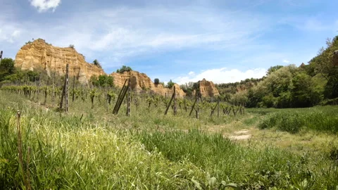 Two hikers walking through a beautiful valley surrounded by badlands Stock Footage 132394024
