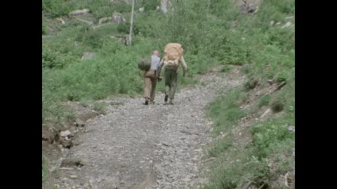 Two hikers walking towards Mount St. Helens, 1970s Stock Footage 90728450