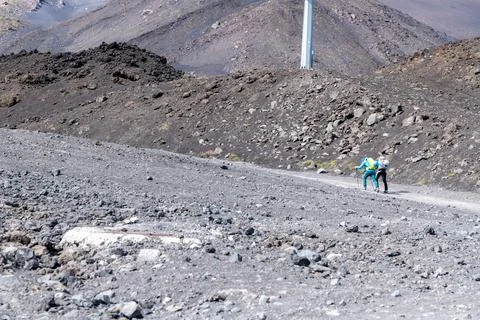 Two Hikers Walking on Volcanic Path at Etna Photos