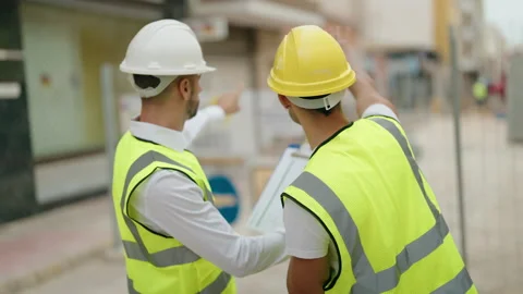 Two hispanic men architects reading document working at street Video stock 230028084
