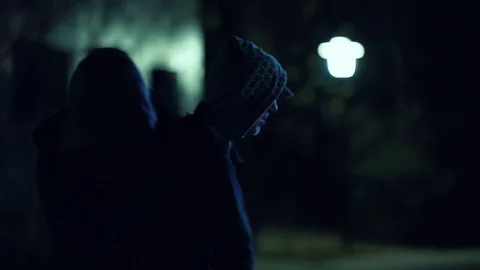 Two hooded men doing transaction at night,suspicious activity Stock Footage 73888661