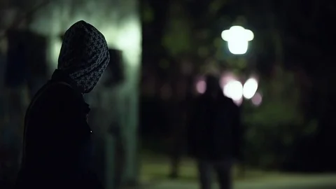 Two hooded men doing transaction at night,suspicious activity Stock Footage 73889004