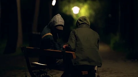 Two hooded men doing transaction at night,suspicious activity Stock Footage 73892845