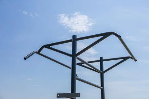 Two horizontal bars stand in a park, inviting individuals to engage in fitn.. Stock Photos