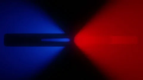Two horizontal beams of light, blue and red, collide with force against a black Stock Footage 157034882