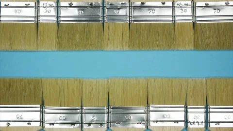 Two horizontal lines of paintbrushes moving like camera shutter. Space for text. Stock Footage 101808195