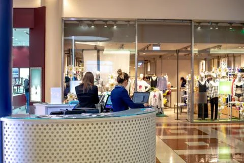 Two Hostess at info point stand at mall Stock Photos