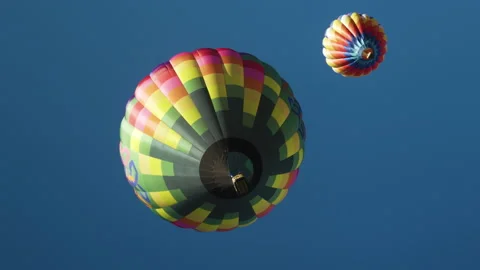Two hot air balloons float in the sky, shot from below Stock Footage 130348240