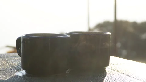 Two Hot Tea or Coffee Cups With Rising Steam in Soft Morning Light Stock Footage 326047657