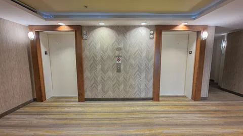 Two hotel elevators in a modern interior hallway Stock Photos