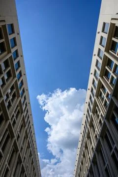 Two house fronts facing each other with blue sky and clouds Stock Photos
