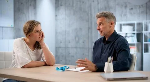 Two HR Managers Talk About Employee Layoffs And Severance Package Details. Stock Photos