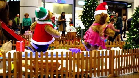 Two huge artificial bears dressed in Santa suites are skating. Stock Footage 138760039