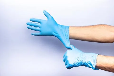 Two human hands in blue nitrile surgical gloves, professional medical safety  Stock Photos