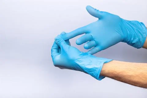 Two human hands in blue nitrile surgical gloves, professional medical safety  Stock Photos
