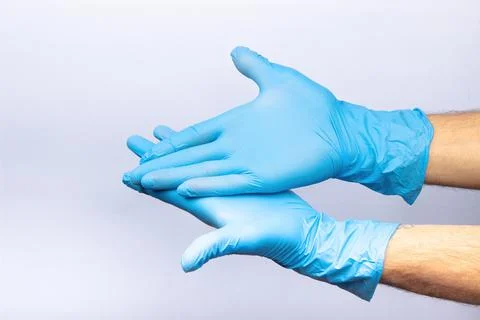 Two human hands in blue nitrile surgical gloves, professional medical safety  Stock Photos