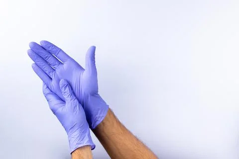 Two human hands in blue nitrile surgical gloves, professional medical safety  Stock Photos