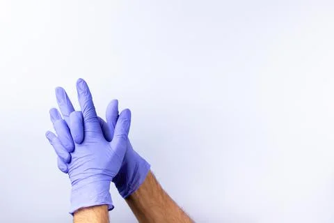Two human hands in blue nitrile surgical gloves, professional medical safety  Stock Photos