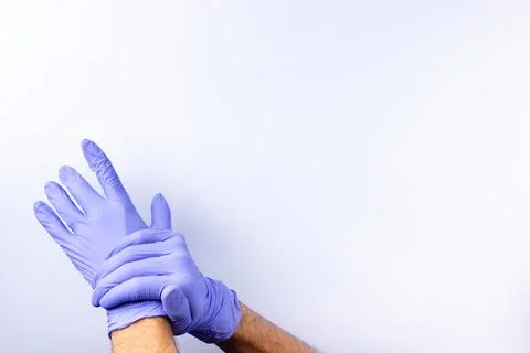 Two human hands in blue nitrile surgical gloves, professional medical safety  Stock Photos