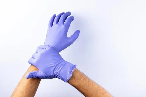 Two human hands in blue nitrile surgical gloves, professional medical safety  Stock Photos