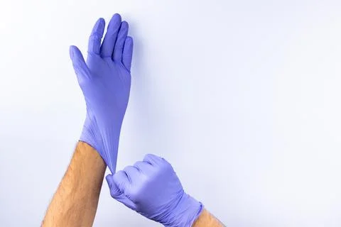 Two human hands in blue nitrile surgical gloves, professional medical safety  Stock Photos