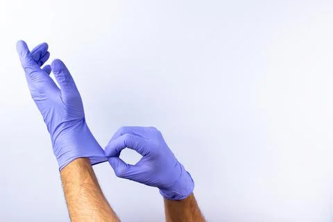 Two human hands in blue nitrile surgical gloves, professional medical safety  Stock Photos