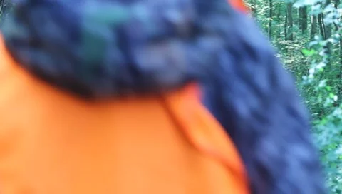 Two hunters walking down path in woods away from camera(HD) c Stock Footage 8655620