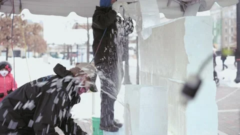 Two ice carvers making ice sculpture at winter festival in Indiana Stock Footage 151183608