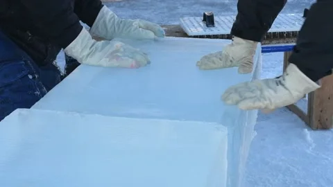Two ice carvers moving ice block together for ice sculpting competition Stock Footage 147342382