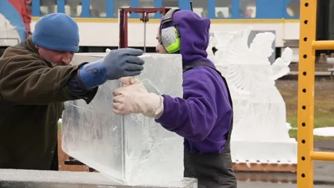 Two ice carvers moving ice block together in Ononadga County, New York Stock Footage 147900891