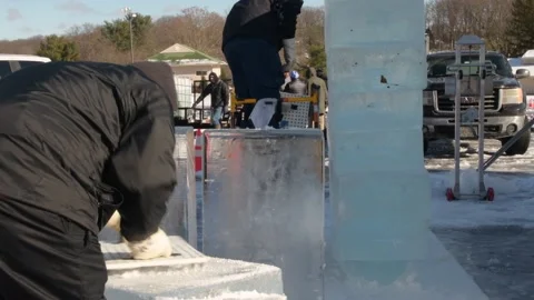 Two ice carvers working together for ice sculpting competition in Maryland Stock Footage 146916778