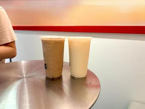 Two iced beverages on a metal table. Stock Photos