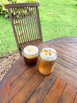 Two iced coffee drinks on a rustic wooden table with beverage, caffeine Stock-Fotos