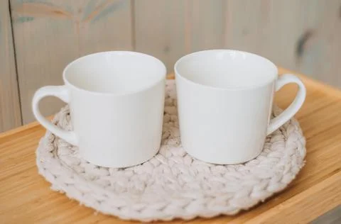 Two identical cups on a black background Stock Photos