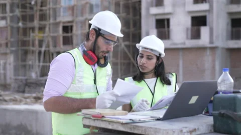 Two Indian engineers on Construction Site using papers and Looking at laptop. Stock Footage 161810579