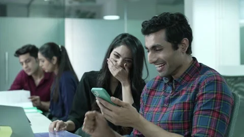 Two Indian friends, worker watching funny videos using smart phone laughing. 動画素材 170126905