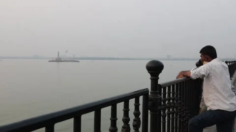 Two indian men talking by the lake India Stock Footage 234631978