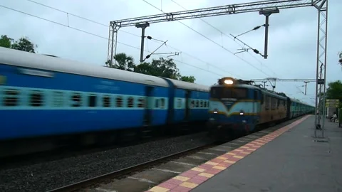 Two Indian Railways Express Passenger Trains meet at Rural train Station India Stock Footage 133587207