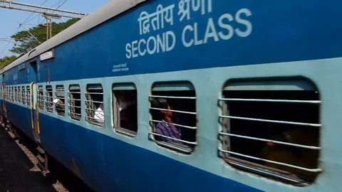 Two Indian railways passenger train meet, View from moving train window, India Stock Footage 106798075