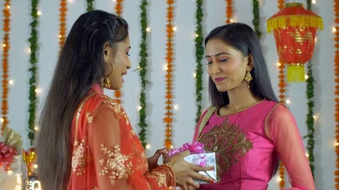Two Indian sisters greeting each other on the occasion of Diwali festival Stock-Footage 117483789
