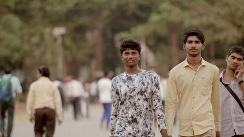 Two Indian students walking towards the camera and smile 스톡 동영상 90978965